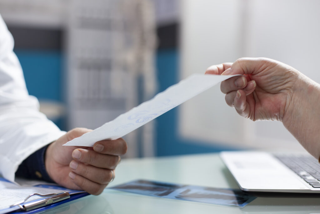 Doctor gives medical document in clinic